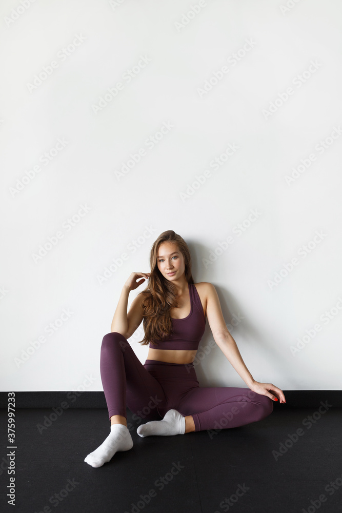 Portrait of a healthy young woman on a white background. Healthy lifestyle, motivation and a beautiful figure.