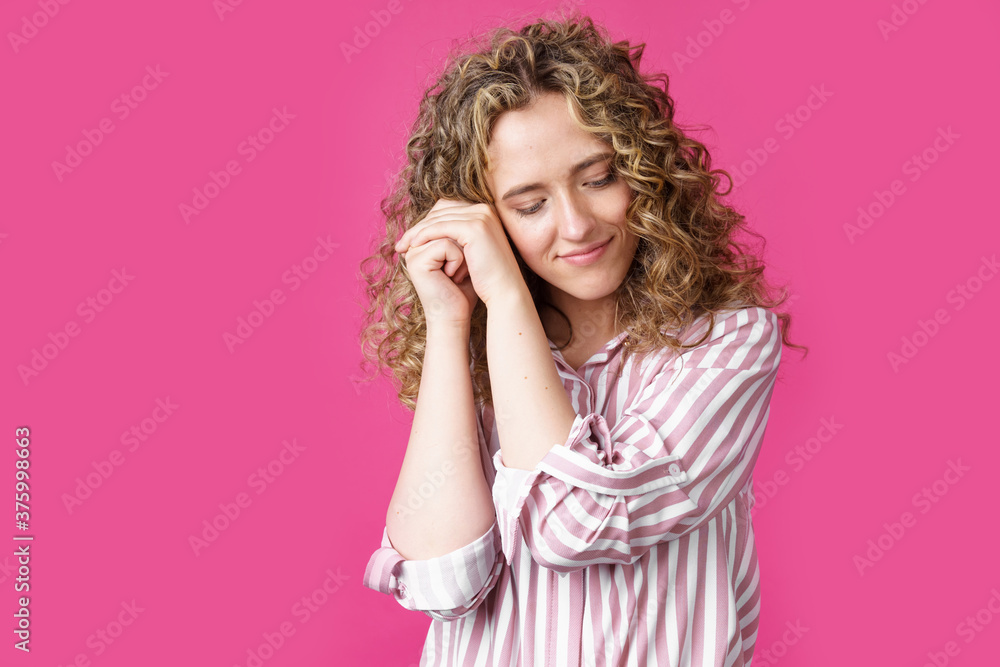 Happy contented woman holds her hands together near the face. Happy contented woman holds her hands together near the face.