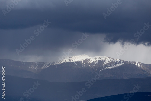 mountain pick with snow and heavy clouds in winter season in Ioannina Greece