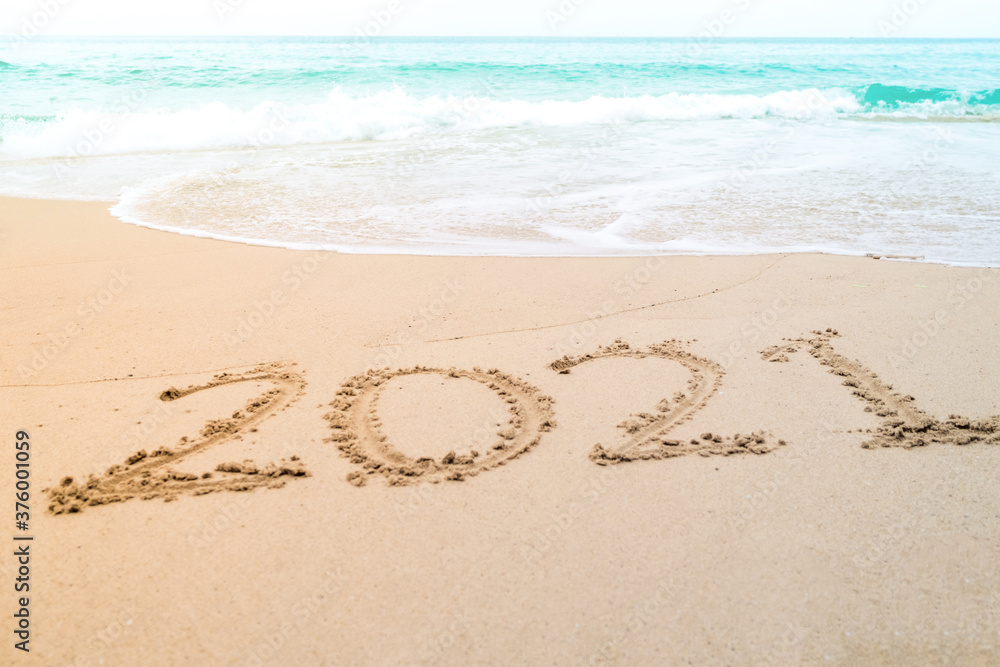 2021 year hand drawn on sand summer beach. 2021 year hand drawn on sand summer beach.