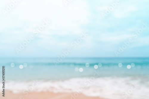 Blur tropical nature clean beach and white sand in summer with sun light blue sky and bokeh © ant