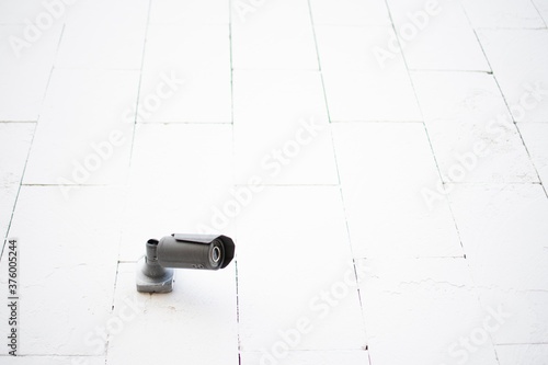 outdoor video surveillance camera on a white wall. minimalism