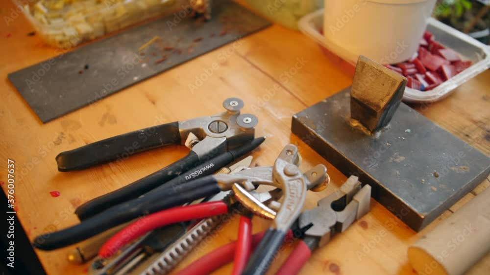 Mosaic tools: cutting pliers, tongs and other instruments on a table at workshop Mosaic tools: cutting pliers, tongs and other instruments on a table at workshop