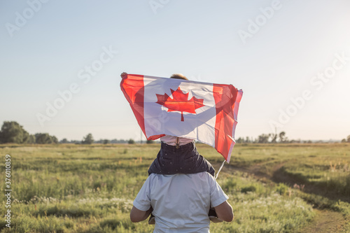 Vászonkép Attractive old senior  man and grahdson holding Canadian Flag