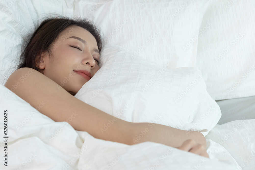 Asian women sleeping and sweet dream on white bed in bedroom Asian women sleeping and sweet dream on white bed in bedroom