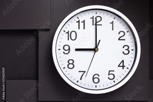 wall clock at black abstract background