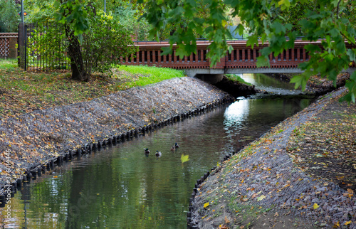 canal with water brick bridge in the park