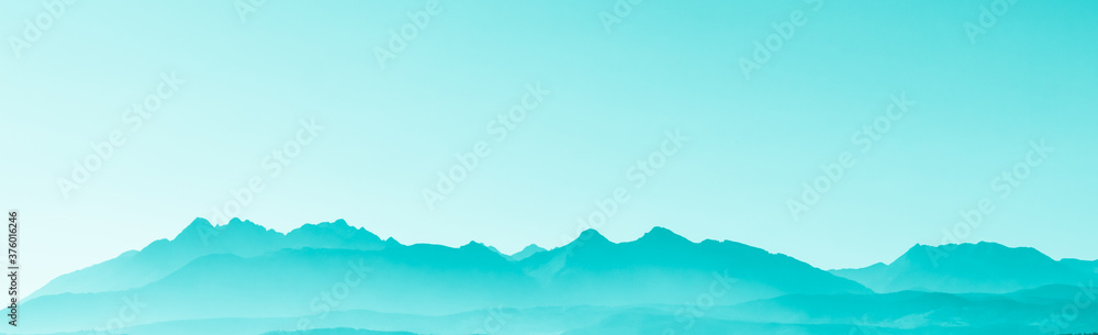 Green surreal mountains against the backdrop of a turquoise sky, fantastic fairytale mountain landscape