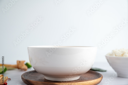 White soup cup with side dishes placed on a white background.