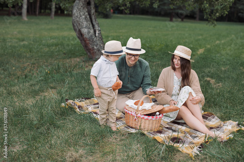 Family having picnic in park. Happy moments together.