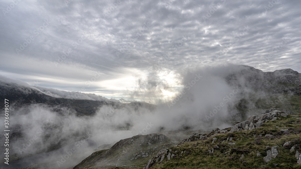 Cloud inversion mist rolling up a Welsh mountain in Snowdonia