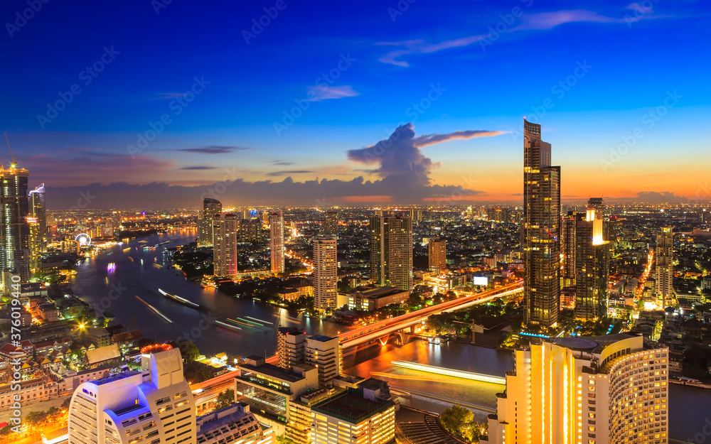 Obraz premium The Capital in the Cityscape view of Bangkok modern office business building in business zone and expressway as long exposure at Bangkok,Thailand