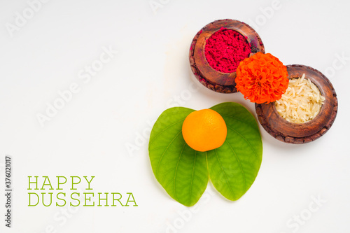 Happy Dussehra greeting card , green apta leaf and rice, Indian festival dussehra photo