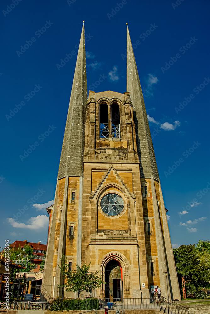 Fototapeta premium Protestant parish church of St. John during sunset at blue sky, Wurzburg, Bavaria, Germany, summer time