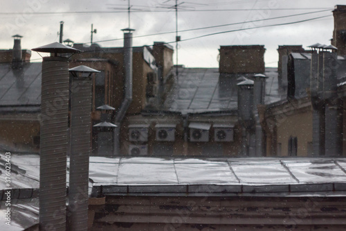 Old city roofs during heavy rain, Saint-Petersburg, Russia © Anton