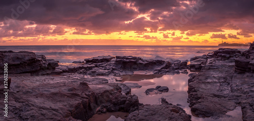 Beautiful Panoramic Golden Seaside Sunrise with Rockpool Reflections