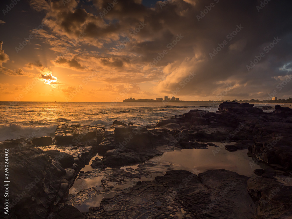 Golden Seaside Sunrise with Rockpool Reflections and Crashing Waves Golden Seaside Sunrise with Rockpool Reflections and Crashing Waves
