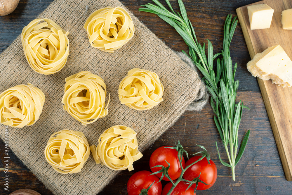 Italian rolled fresh fettuccine pasta. Italian food concept. Italian rolled fresh fettuccine pasta. Italian food concept.