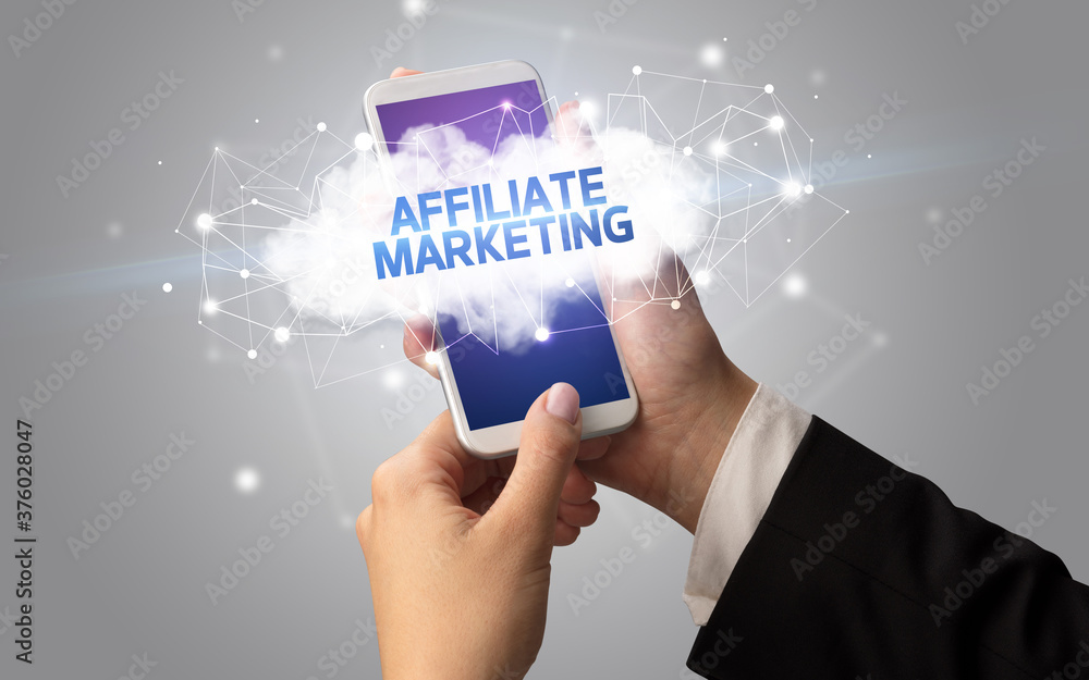 Female hand touching smartphone with AFFILIATE MARKETING inscription, cloud business concept Female hand touching smartphone with AFFILIATE MARKETING inscription, cloud business concept