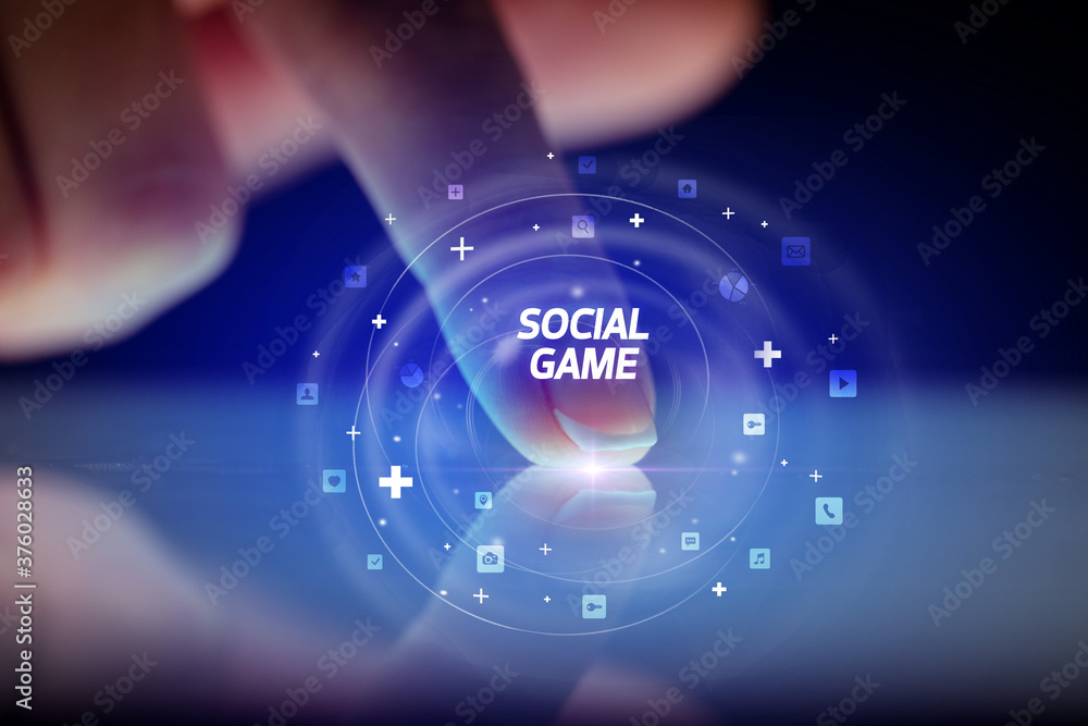 Finger touching tablet with social media icons and SOCIAL GAME Finger touching tablet with social media icons and SOCIAL GAME