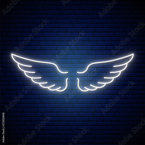 Angel wings neon sign. Bright light banner. Glowing neon white wings icon on dark brick wall background. Vector illustration.