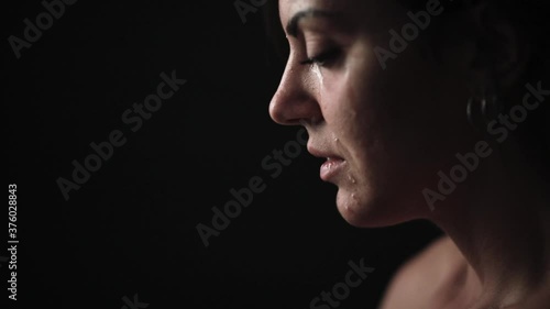 Zoom in and out of a Crying Woman on Black Background with Natural Makeup photo