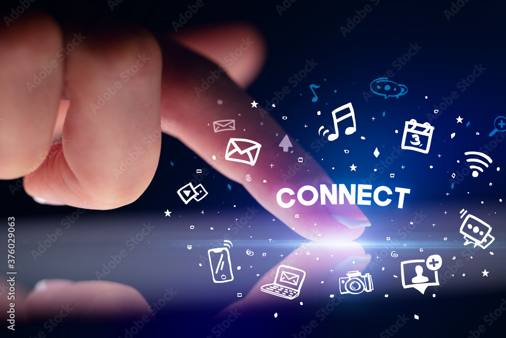 Finger touching tablet with drawn social media icons and CONNECT inscription, social networking concept