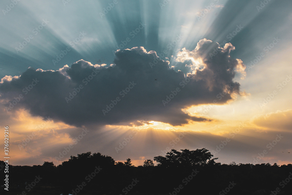Sun rays with dark clouds in day