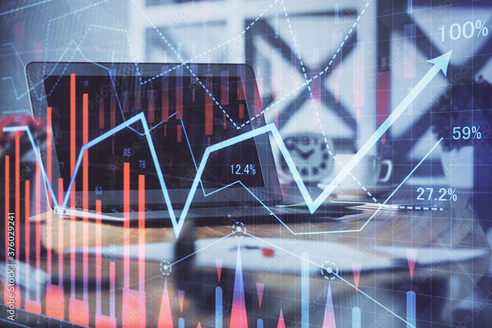 Stock market chart hologram drawn on personal computer background. Double exposure. Concept of investment. Stock market chart hologram drawn on personal computer background. Double exposure. Concept of investment.