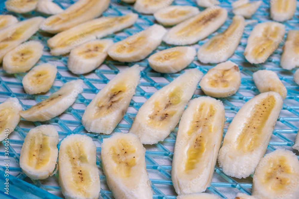 Banana slices in perspective on dehydrator tray