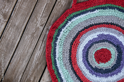 Colorful knitted carpet form used shirts, recycle concept