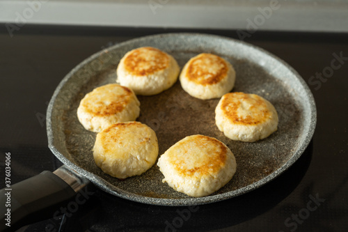 Six cheese pancakes on a pan (Selective focus)