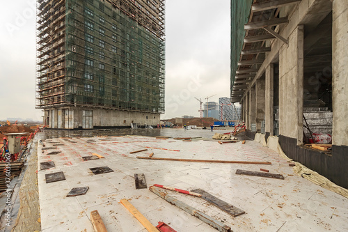 Construction of a monolithic house. Stylobate. Construction site residential house, office apartment. High-rise facade of multi-story. Monolithic brick structure. Rainscreen is exterior wall photo