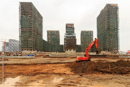 Construction of a monolithic house. Stylobate. Construction site residential house, office apartment. High-rise facade of multi-story. Monolithic brick structure. Rainscreen is exterior wall photo