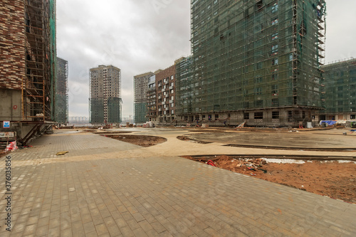 Construction of a monolithic house. Stylobate. Construction site residential house, office apartment. High-rise facade of multi-story. Monolithic brick structure. Rainscreen is exterior wall photo