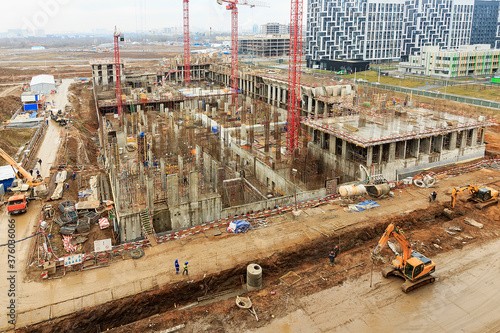 Construction of a monolithic house. Stylobate. Construction site residential house, office apartment. High-rise facade of multi-story. Monolithic brick structure. Rainscreen is exterior wall photo