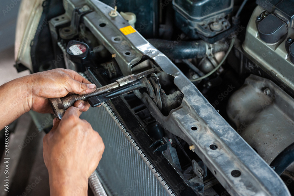 Hands of mechanic working in auto repair shop Hands of mechanic working in auto repair shop