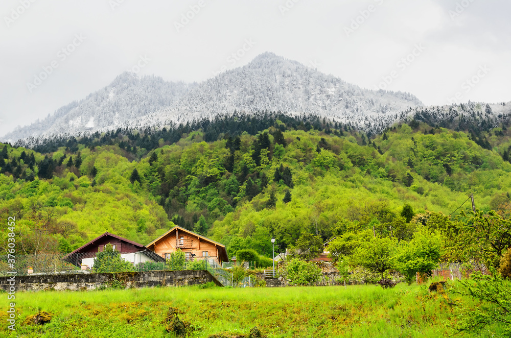 Mountain village in the French alps at the foot of the snow-capped mountains framing the Geneva lake Mountain village in the French alps at the foot of the snow-capped mountains framing the Geneva lake