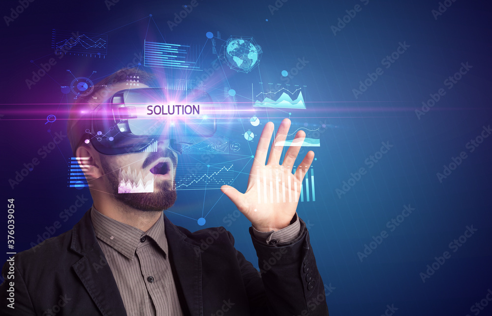 Businessman looking through Virtual Reality glasses with SOLUTION inscription, new business concept Businessman looking through Virtual Reality glasses with SOLUTION inscription, new business concept