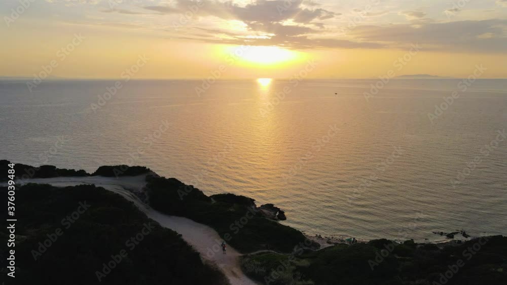 Magical tracking shot aerial drone view of coastline at sunset in Sardinia, Italy Magical tracking shot aerial drone view of coastline at sunset in Sardinia, Italy