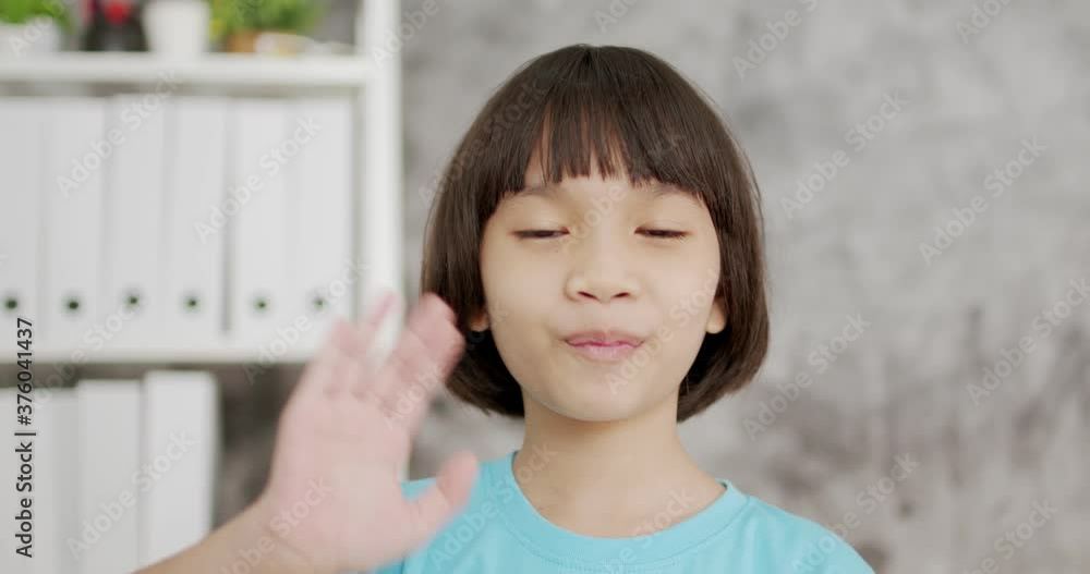 Thai Asian kid girl wave and smiled to camera Thai Asian kid girl wave and smiled to camera