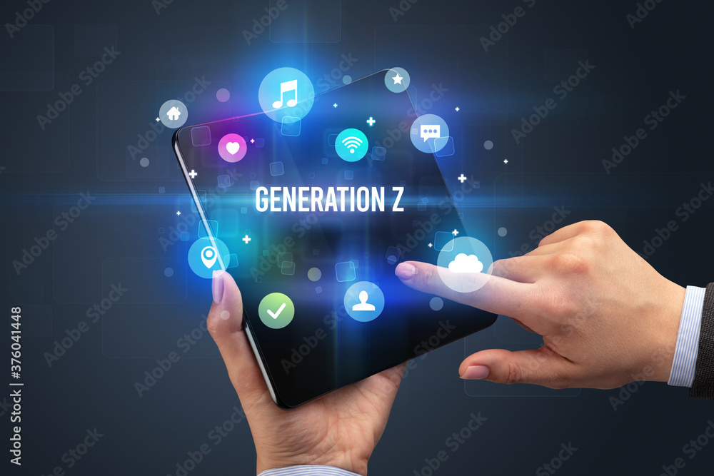 Businessman holding a foldable smartphone with GENERATION Z inscription, social media concept Businessman holding a foldable smartphone with GENERATION Z inscription, social media concept