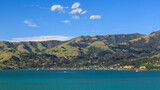 Panoramic view of the town of Akaroa, New Zealand, and the surrounding hills, seen from the harbor