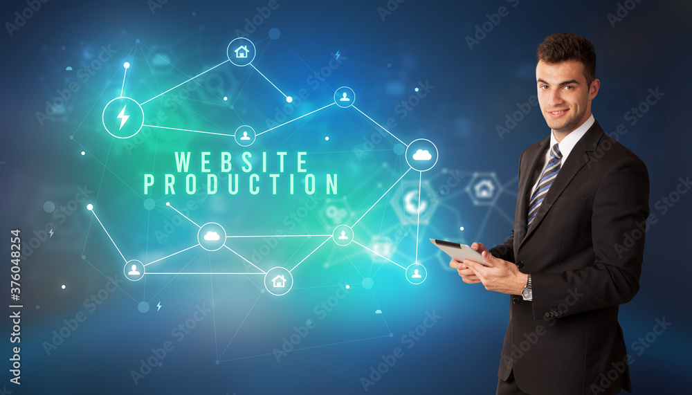 Businessman in front of cloud service icons with WEBSITE PRODUCTION inscription, modern technology concept Businessman in front of cloud service icons with WEBSITE PRODUCTION inscription, modern technology concept