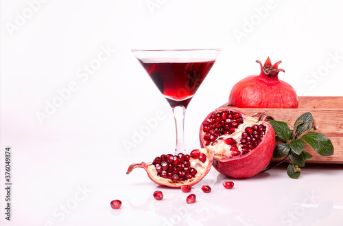 Glass of pomegranate juice with fresh fruits. Pomegranate juice in a martini glasses.