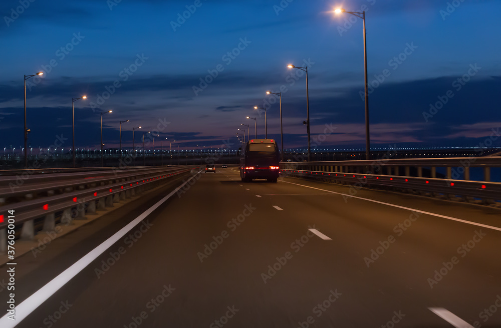 traffic on the highway outside the city at night