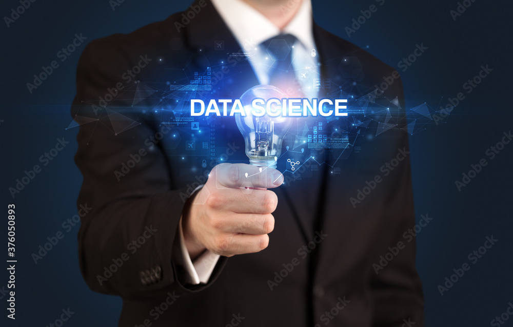 Fototapeta premium Businessman holding light bulb with DATA SCIENCE inscription, innovative technology concept