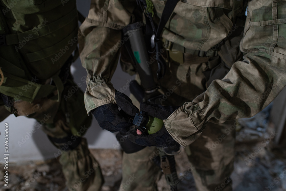 Close-up grenade in the hands of an airsoft player Close-up grenade in the hands of an airsoft player