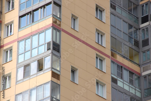 Windows of a multi-storey residential building close-up © Natalia