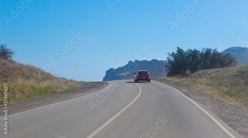 Car Moves along a winding road © Yuri Bizgaimer